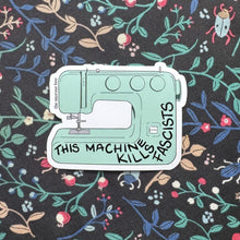 Load image into Gallery viewer, Sewing machine design with text 'This Machine Kills Fascists' on a floral patterned background
