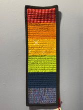 Load image into Gallery viewer, Colorful woven strip with a pattern on a gray surface
