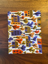 Load image into Gallery viewer, Fabric with colorful house pattern on a wooden surface
