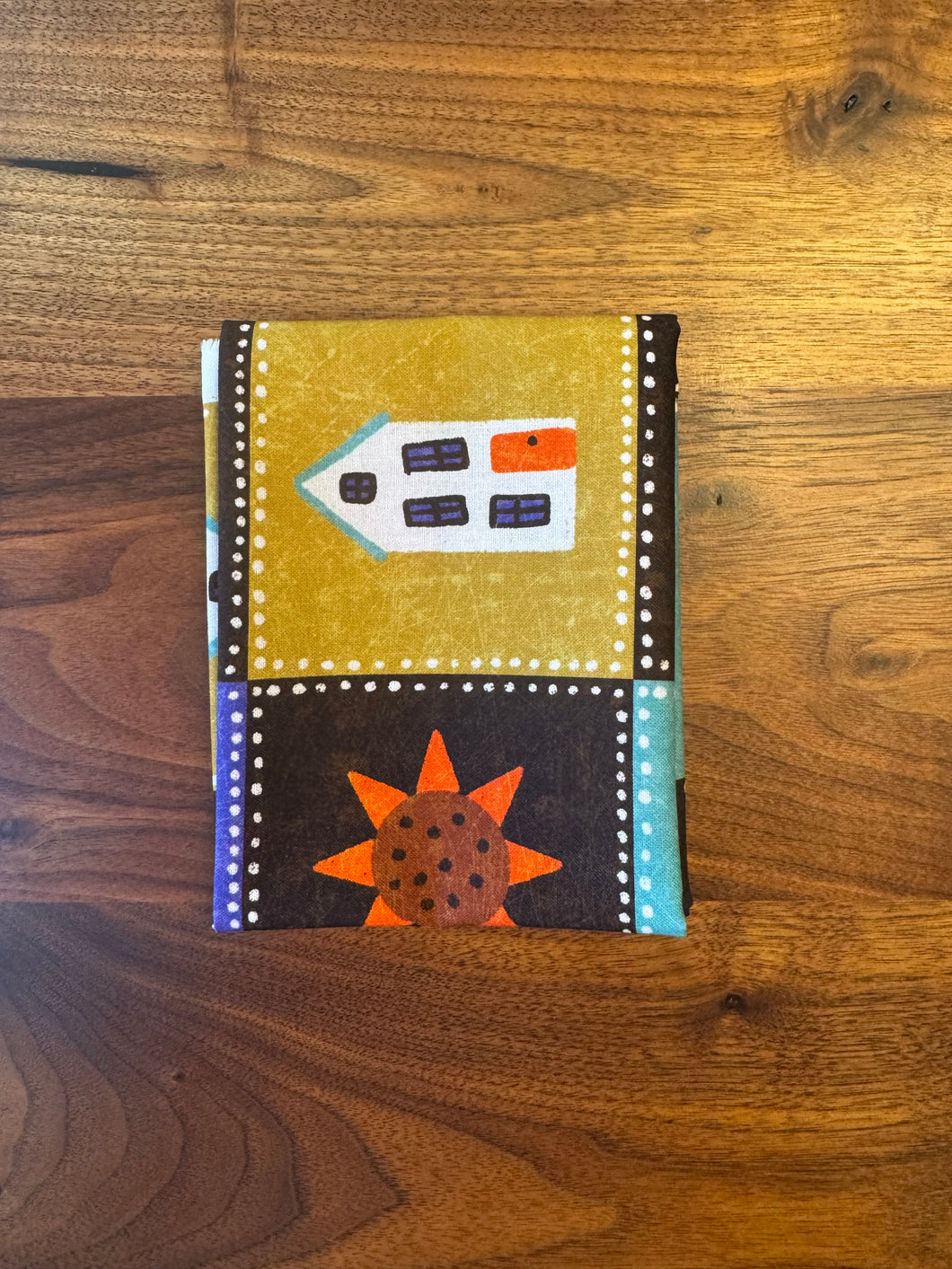 Small fabric pouch with geometric design on a wooden surface