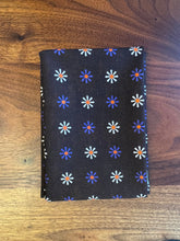 Load image into Gallery viewer, Folded dark brown fabric with floral pattern on a wooden surface
