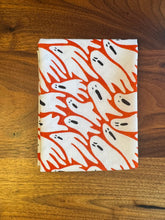 Load image into Gallery viewer, Fabric with orange and white ghost pattern on a wooden surface

