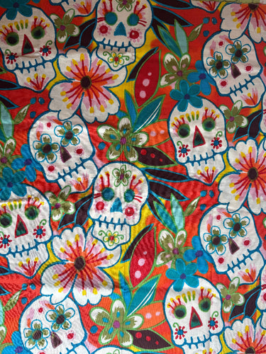 Colorful fabric with a floral and sugar skull pattern